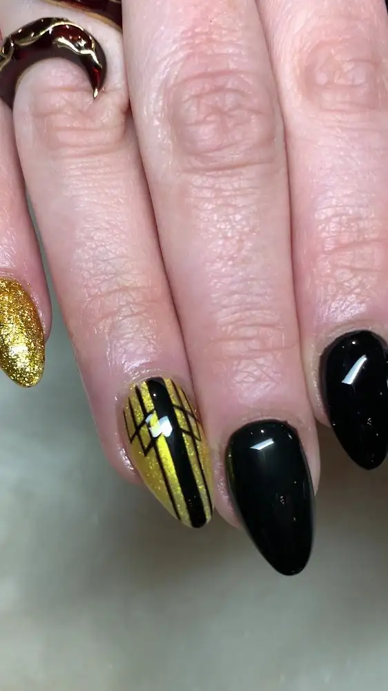 Black almond nails with gold accent