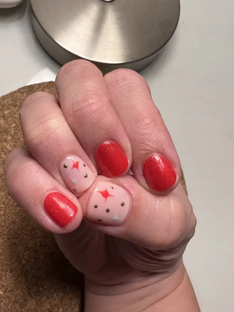 Red gel nails with star accents